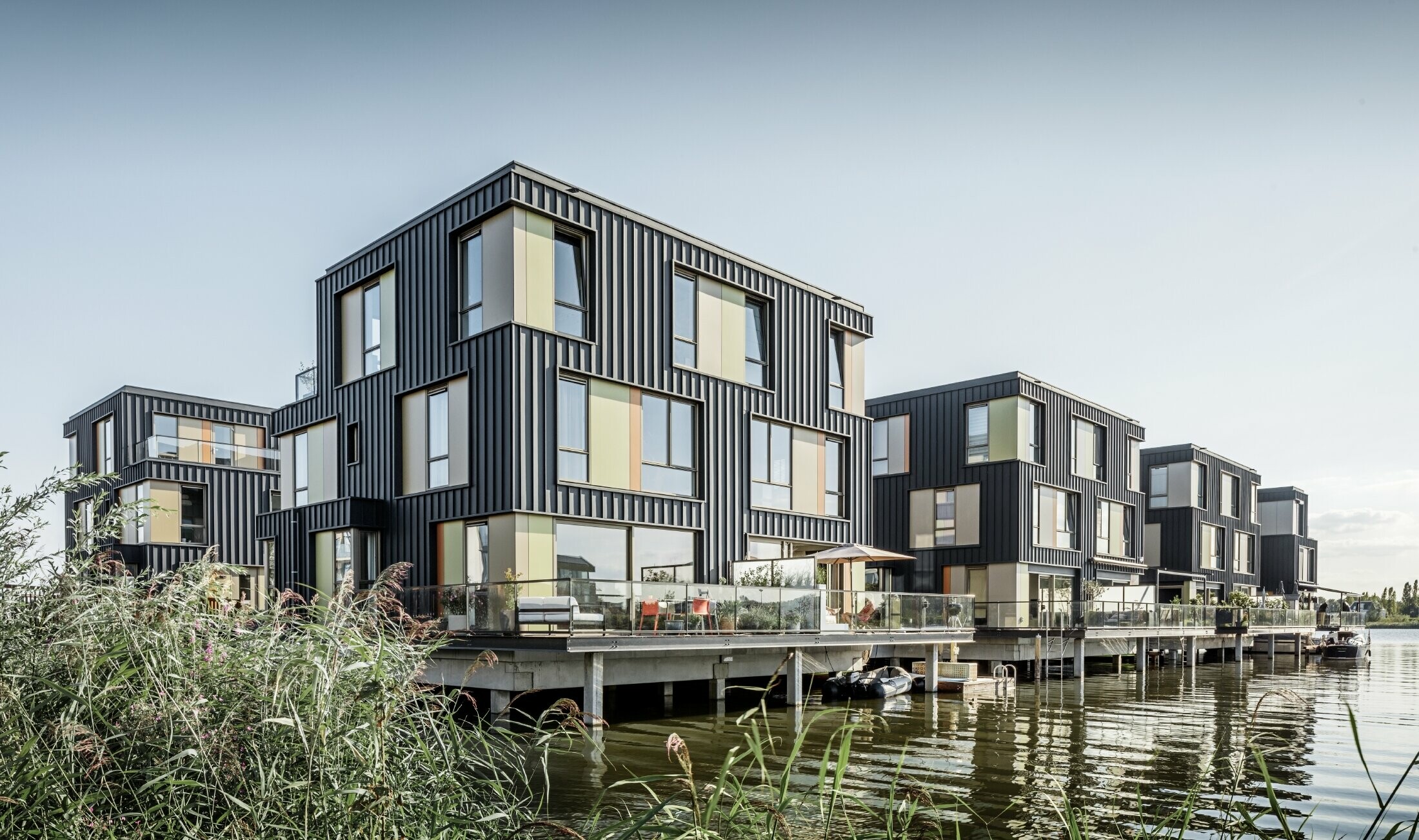 Neuer Wohnpark mit Zweifamilienhäusern an einem See in Amsterdam. Die Häuser wurden mit Prefalz von PREFA in P.10 Anthrazit bekleidet.