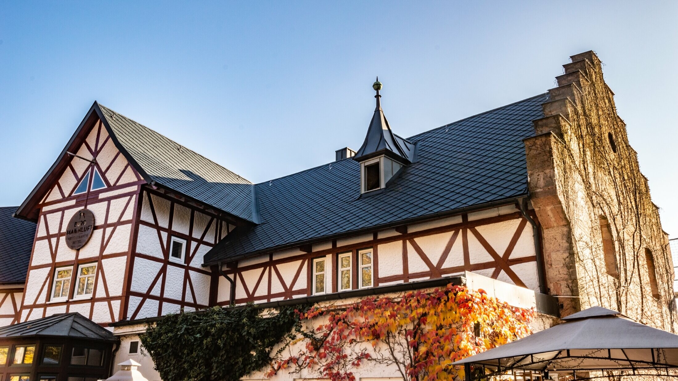 Das Hotel Burg Maienluft wurde mit der PREFA Dachraute 29 × 29 in Anthrazit neu eingedeckt, die Fassade ist eine Fachwerk-Fassade.