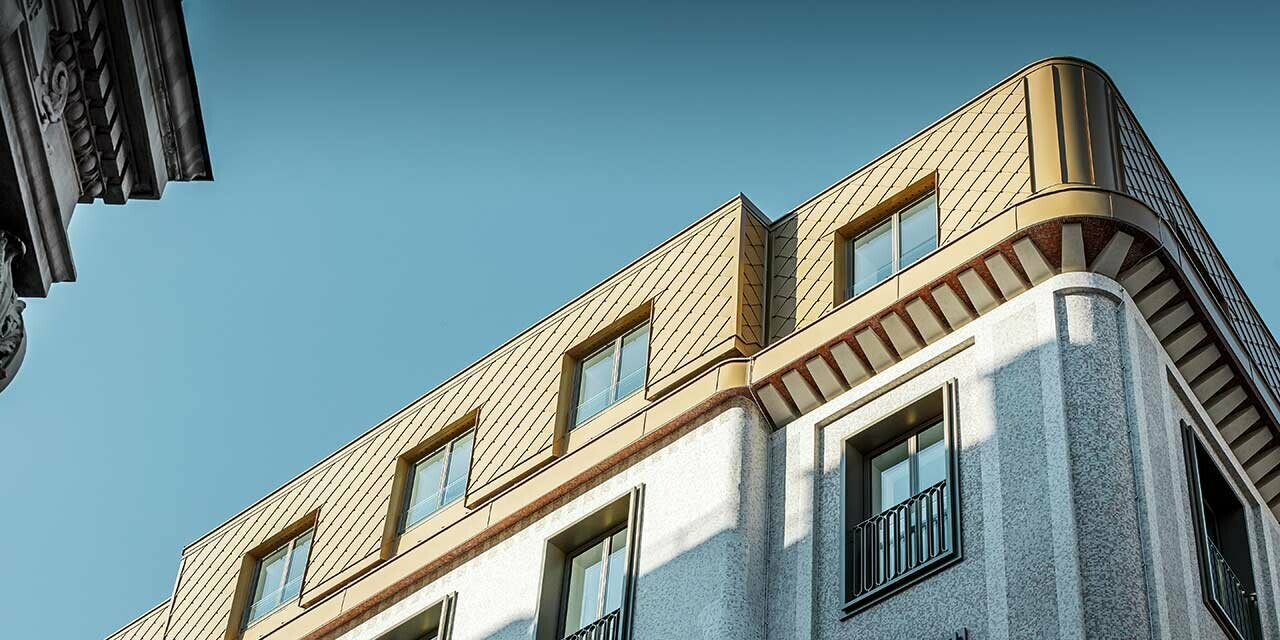 Dachgeschossausbau der Korb Etagen in Wien. Der Aufbau wurde mit der PREFA Wandraute 29 × 29 in Perlgold verkleidet.